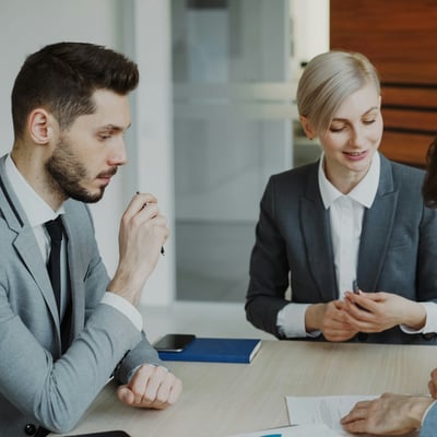 Legal professionals collaborating around a table in a bright office
